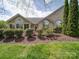 Charming stone home with manicured landscaping and mature trees, creating inviting curb appeal at 4754 Polo Gate Blvd, Charlotte, NC 28216