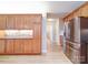 Open kitchen featuring wood cabinets, stone backsplash, stainless appliances and woodgrain tile floor at 4754 Polo Gate Blvd, Charlotte, NC 28216