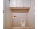 Clean laundry room featuring white cabinets, washer hookups and woodgrain tile flooring at 4754 Polo Gate Blvd, Charlotte, NC 28216