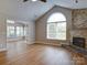 Spacious living room with hardwood floors, fireplace, and a sunroom, perfect for relaxing and entertaining at 4754 Polo Gate Blvd, Charlotte, NC 28216