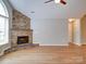 Spacious living room with a stone fireplace and ample natural light creating a comfortable atmosphere at 4754 Polo Gate Blvd, Charlotte, NC 28216