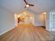 Open-concept living room with vaulted ceiling, neutral walls and wood-look flooring at 4754 Polo Gate Blvd, Charlotte, NC 28216