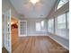 Bright living room featuring vaulted ceilings, many windows, and wood-look floors at 4754 Polo Gate Blvd, Charlotte, NC 28216