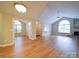 Large living room featuring a fireplace, vaulted ceilings, and wood-look floors at 4754 Polo Gate Blvd, Charlotte, NC 28216