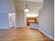 Open-concept living room with neutral walls and wood-look flooring at 4754 Polo Gate Blvd, Charlotte, NC 28216