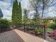 Brick patio showcasing mature landscaping with beautiful shrubbery and trees at 4754 Polo Gate Blvd, Charlotte, NC 28216