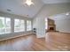 Bright sunroom featuring hardwood floors, large windows, and an open doorway to the living room, offering relaxation at 4754 Polo Gate Blvd, Charlotte, NC 28216