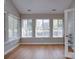 Sun-drenched sunroom featuring bright windows and hardwood floors, offering a peaceful space to relax at 4754 Polo Gate Blvd, Charlotte, NC 28216