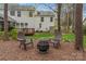 The backyard features a stone firepit area with Adirondack chairs and a view of the home at 5225 Mcchesney Dr, Charlotte, NC 28269