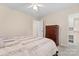Bedroom with neutral walls and carpet features a ceiling fan and large chest of drawers at 5225 Mcchesney Dr, Charlotte, NC 28269