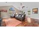 Spacious bonus room with hardwood floors, a large window, and comfortable seating area, perfect for relaxation at 5225 Mcchesney Dr, Charlotte, NC 28269