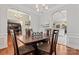 Formal dining room featuring hardwood floors, chair rail, and decorative lighting with open access to living spaces at 5225 Mcchesney Dr, Charlotte, NC 28269