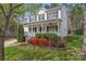 Inviting two-story home with a classic porch, complemented by colorful landscaping and mature trees at 5225 Mcchesney Dr, Charlotte, NC 28269