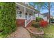 Charming front porch with brick accents, leading to a beautifully landscaped yard at 5225 Mcchesney Dr, Charlotte, NC 28269