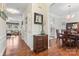 Spacious hallway showcasing hardwood floors, elegant trim, and seamless transition to dining area at 5225 Mcchesney Dr, Charlotte, NC 28269