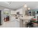 Open kitchen features white cabinetry, stainless appliances, a breakfast bar, and views of living spaces at 5225 Mcchesney Dr, Charlotte, NC 28269