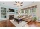 Comfortable living room with hardwood floors, a fireplace, built-in shelving, and large windows at 5225 Mcchesney Dr, Charlotte, NC 28269