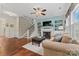 Cozy living room featuring a fireplace, built-in shelving, hardwood floors, and stairs to upper level at 5225 Mcchesney Dr, Charlotte, NC 28269