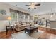 Inviting living room featuring a comfortable sofa, stylish decor, and a seamless transition to the kitchen area at 5225 Mcchesney Dr, Charlotte, NC 28269