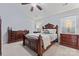 Serene main bedroom with a carved wood bed, dresser, and natural light, creating a restful retreat at 5225 Mcchesney Dr, Charlotte, NC 28269
