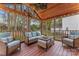 Covered porch with wood ceiling, outdoor seating, and decorative flowers at 5225 Mcchesney Dr, Charlotte, NC 28269