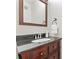 Elegant powder room with a dark wood vanity, granite countertop, and stylish mirror and towel holder at 5225 Mcchesney Dr, Charlotte, NC 28269
