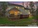 The rear exterior of the home showcases a screened porch and deck for outdoor relaxation and entertainment at 5225 Mcchesney Dr, Charlotte, NC 28269