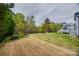 The backyard has mature trees, lawn, a black metal fence and a deck for outdoor enjoyment at 615 Reliance Ct, Tega Cay, SC 29708