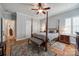 Bedroom featuring a four-poster bed, hardwood floors, and neutral-toned walls and decor at 615 Reliance Ct, Tega Cay, SC 29708