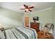 Bedroom with green walls, wood floors, and dresser with a television above at 615 Reliance Ct, Tega Cay, SC 29708