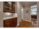 Butler pantry with granite counters, dark wood cabinets, and access to other areas at 615 Reliance Ct, Tega Cay, SC 29708