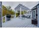 The rear deck has a white pergola, patio furniture, and a grill, ideal for entertaining at 615 Reliance Ct, Tega Cay, SC 29708