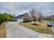 The brick home features a well-maintained lawn, a driveway, and mature trees at 615 Reliance Ct, Tega Cay, SC 29708