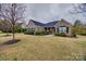 Charming single-story brick home with manicured lawn, mature trees, and a welcoming entrance at 615 Reliance Ct, Tega Cay, SC 29708