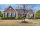Charming brick home with well-manicured lawn and mature landscaping in a peaceful neighborhood at 615 Reliance Ct, Tega Cay, SC 29708