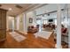 Spacious hallway leading to open-concept living area with hardwood floors and classic columns at 615 Reliance Ct, Tega Cay, SC 29708