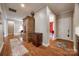 Hardwood hallway featuring a built-in armoire, doorway to another room and front door at 615 Reliance Ct, Tega Cay, SC 29708
