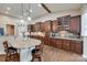 Gourmet kitchen featuring granite countertops, custom cabinetry, and a breakfast bar with seating at 615 Reliance Ct, Tega Cay, SC 29708
