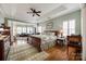 Spacious main bedroom with attached sitting area, hardwood floors, and neutral colored walls at 615 Reliance Ct, Tega Cay, SC 29708