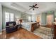 Spacious main bedroom with a sitting area and en-suite bathroom featuring beautiful hardwood floors at 615 Reliance Ct, Tega Cay, SC 29708