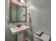 Stylish powder room with pedestal sink, decorative mirror, and fresh, clean design at 615 Reliance Ct, Tega Cay, SC 29708