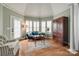 Sitting room with hardwood floors, and a blue sofa with white shutters at 615 Reliance Ct, Tega Cay, SC 29708