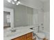 Bathroom with a single sink vanity, large mirror, and a shower-tub combo at 6512 Quarterbridge Ln, Charlotte, NC 28262