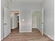 Bedroom featuring wood floors, walk-in closet, and an adjacent bathroom at 6512 Quarterbridge Ln, Charlotte, NC 28262