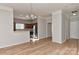 Open dining area with wood floors and a chandelier, next to the kitchen at 6512 Quarterbridge Ln, Charlotte, NC 28262
