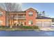 Brick and siding townhome featuring a two-car garage and second story porch at 6512 Quarterbridge Ln, Charlotte, NC 28262