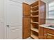 A large kitchen pantry with adjustable shelves provides ample storage space at 6512 Quarterbridge Ln, Charlotte, NC 28262