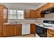 Traditional kitchen featuring wood cabinets, laminate countertops, and standard appliances at 6512 Quarterbridge Ln, Charlotte, NC 28262
