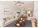 Bright living room featuring neutral tones, a dining area, and a glimpse into the well-lit, functional kitchen at 6512 Quarterbridge Ln, Charlotte, NC 28262