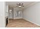 Inviting living room with wood floors, natural light, and a cozy fireplace at 6512 Quarterbridge Ln, Charlotte, NC 28262